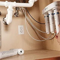 Water Filters can be seen under a sink cupboard